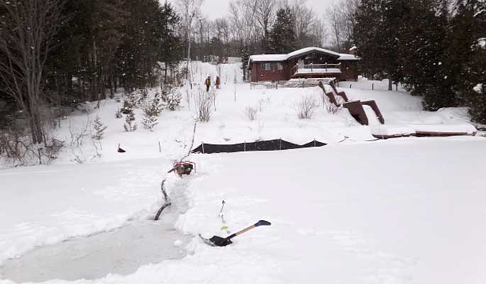 Hole Cut Through Ice Provides Winter Water Source (Northern Ontario)